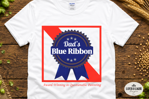 White t-shirt with 'Dad's Blue Ribbon' graphic on a wooden surface