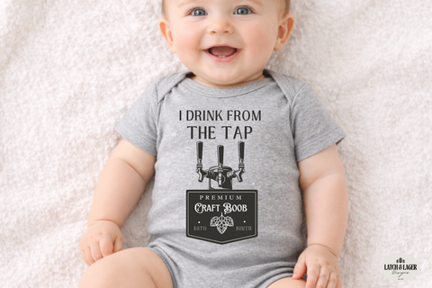 Baby wearing a gray onesie with humorous text design on a light background