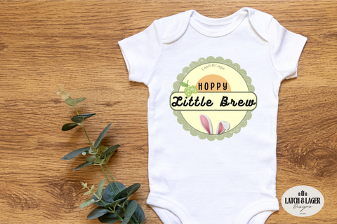Baby onesie with 'Hoppy Little Brew' design on a wooden surface