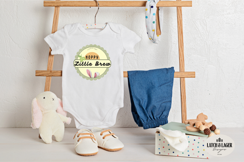 Baby clothing and accessories on a wooden rack with a white background