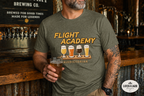 Person wearing a green t-shirt with 'Flight Academy' design, holding a beer in a bar setting.