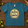 Blue t-shirt with 'Hoppy Little Brew' design on a wooden surface with hops and wheat.
