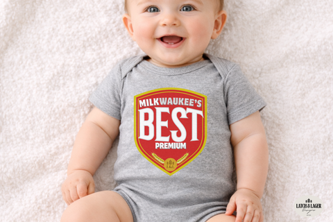 Baby wearing a gray onesie with 'Milkwaukee's Best Premium' text on a light background