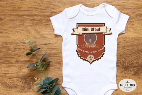 White baby onesie with a brown graphic and text on a wooden surface