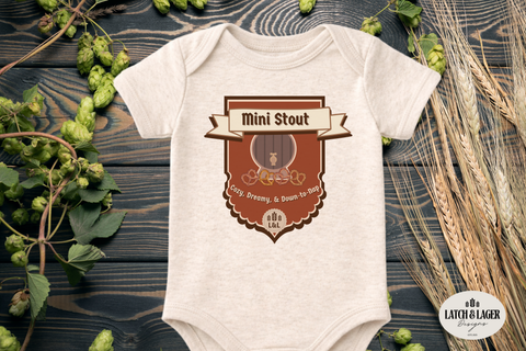 Baby onesie with 'Mini Stout' design on a wooden surface with hops and barley.