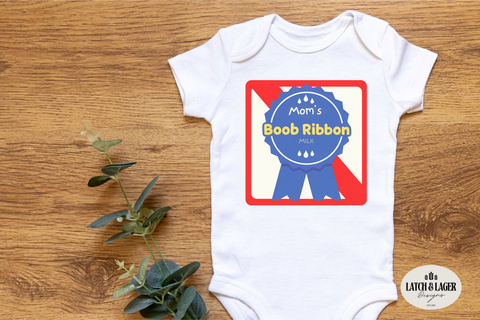 White baby onesie with a graphic design on a wooden surface