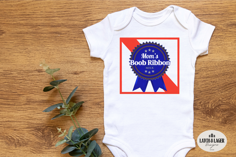 White baby onesie with a graphic design on a wooden surface