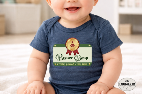 Baby wearing a blue onesie with a graphic design, sitting on a light-colored surface.