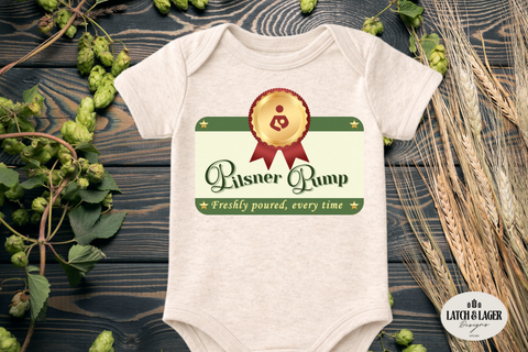 Baby onesie with 'Pilsner Pump' design on a wooden surface with hops and wheat.