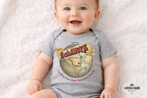 Baby wearing a gray onesie with a graphic design on a light background